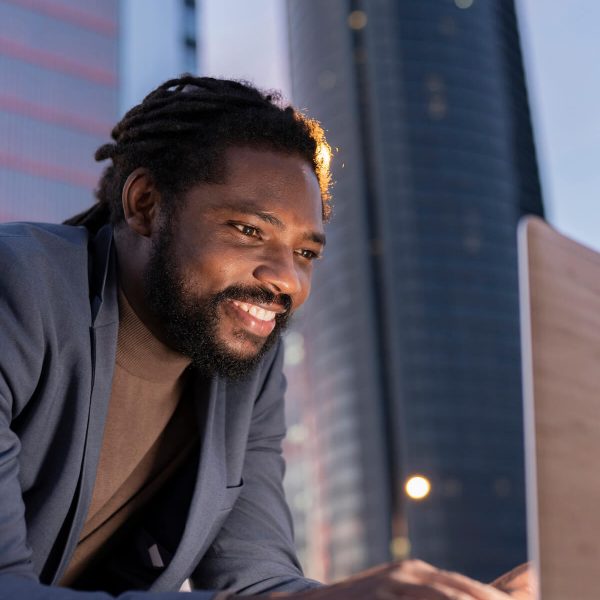 man-in-city-with-laptop-business-at-night-2023-11-27-04-54-11-utc.jpg